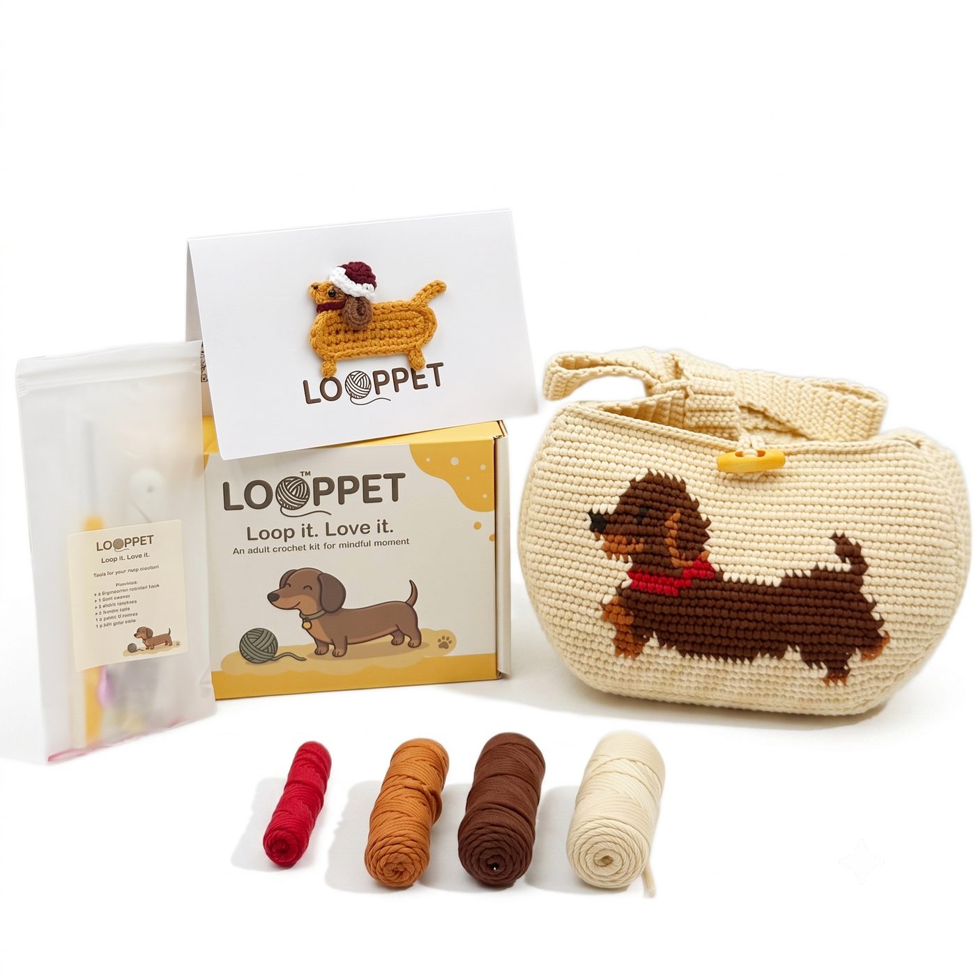 LOOPPET cream crochet bag kit with a pixel-art dachshund, yarn, tools, and printed guide