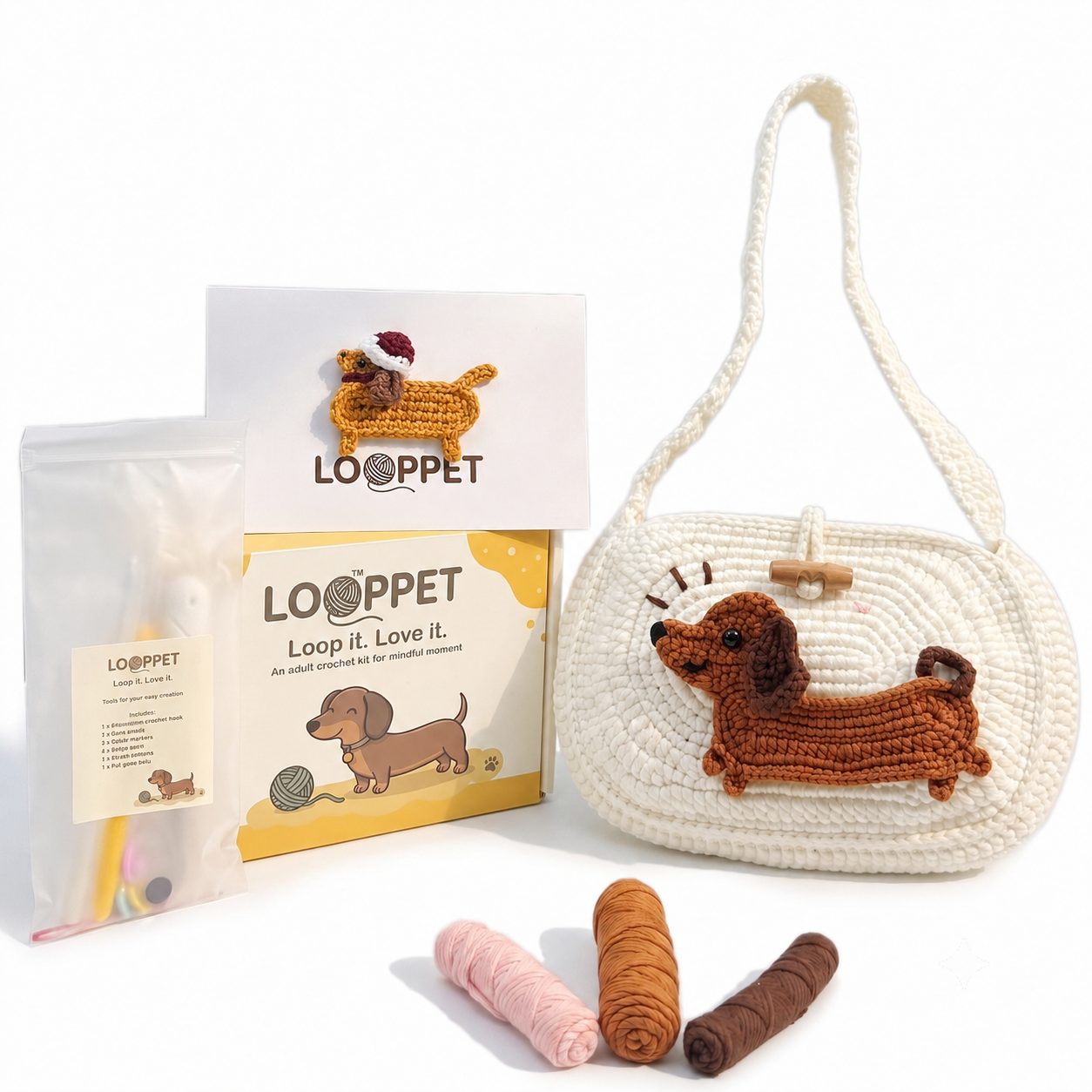 LOOPPET cream shoulder bag crochet kit with a raised dachshund patch, yarn, tools, and printed guide